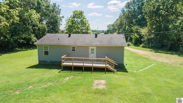 back of property featuring a lawn and a deck