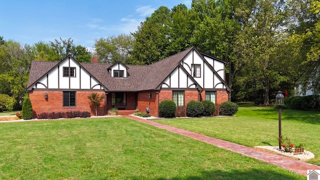 english style home featuring a front lawn