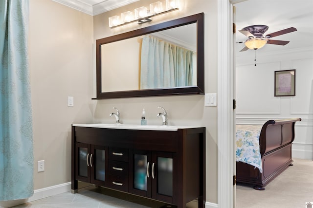 bathroom with ornamental molding, ceiling fan, and vanity