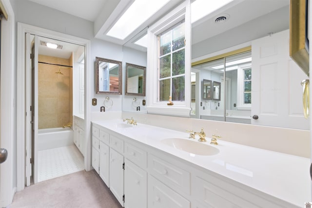 bathroom featuring tiled shower / bath, vanity, plenty of natural light, and tile patterned flooring