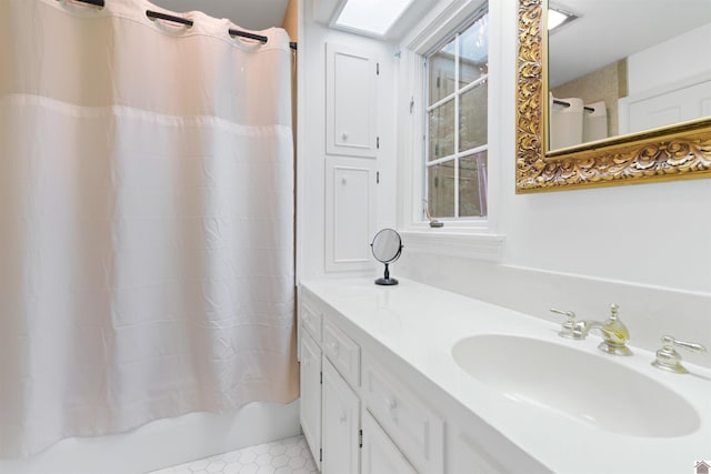 bathroom with shower / bath combination with curtain and vanity