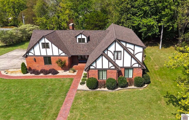 tudor house featuring a front yard