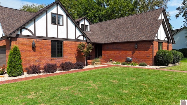 tudor-style house with a front yard