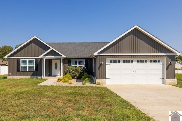 view of front of property with a garage and a front lawn