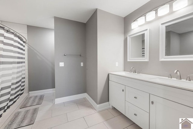 bathroom with tile patterned floors, walk in shower, and vanity