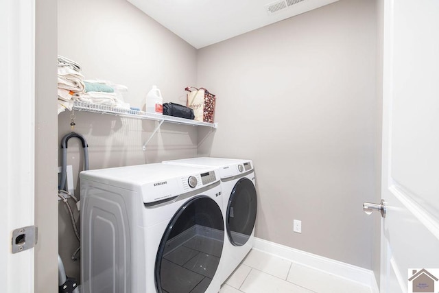 2216 Traci Dr, Murray, KY 42071 - washroom featuring washer and dryer, light tile patterned floors, and baseboards