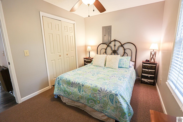 carpeted bedroom featuring a closet, electric panel, and ceiling fan