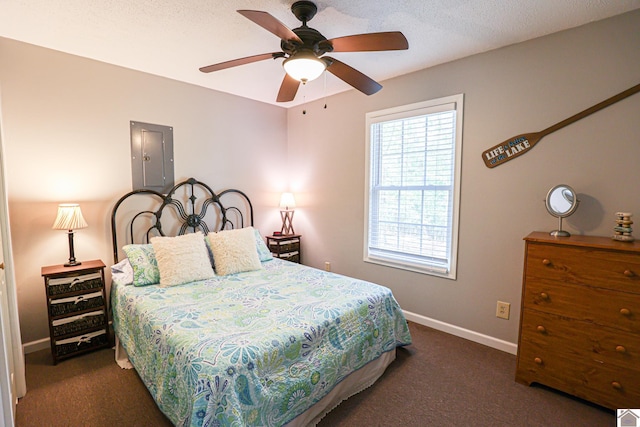 bedroom with ceiling fan, a textured ceiling, and dark colored carpet