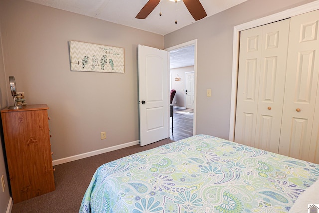 bedroom with dark colored carpet, ceiling fan, and a closet