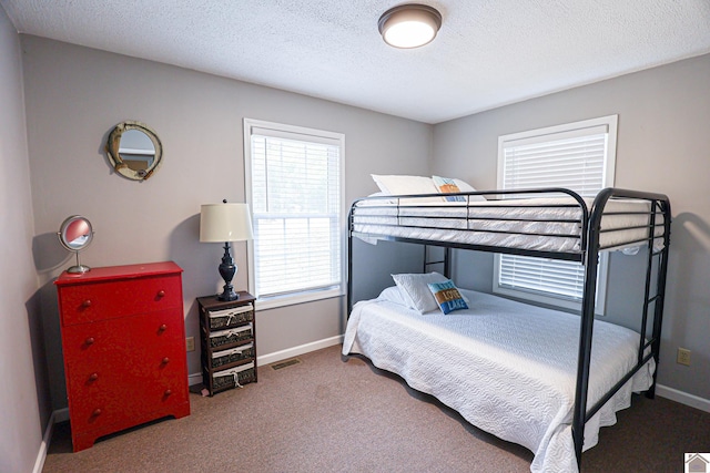 carpeted bedroom featuring a textured ceiling