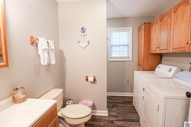 interior space with vanity, a textured ceiling, wood-type flooring, toilet, and washer and dryer