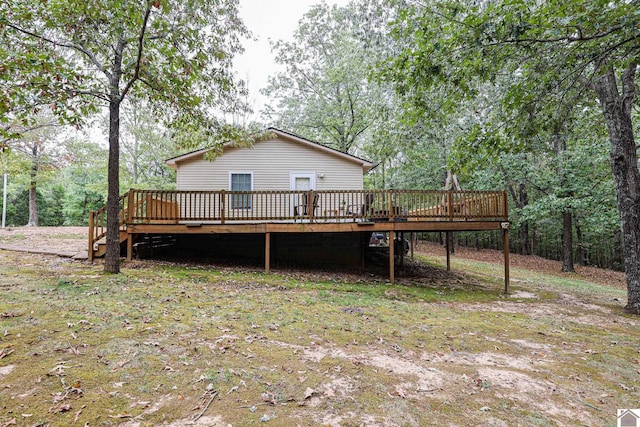 rear view of property featuring a wooden deck