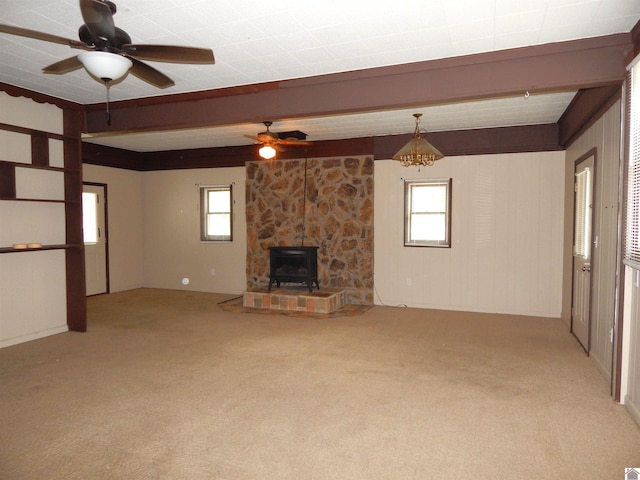 unfurnished living room with ceiling fan, light colored carpet, and a healthy amount of sunlight