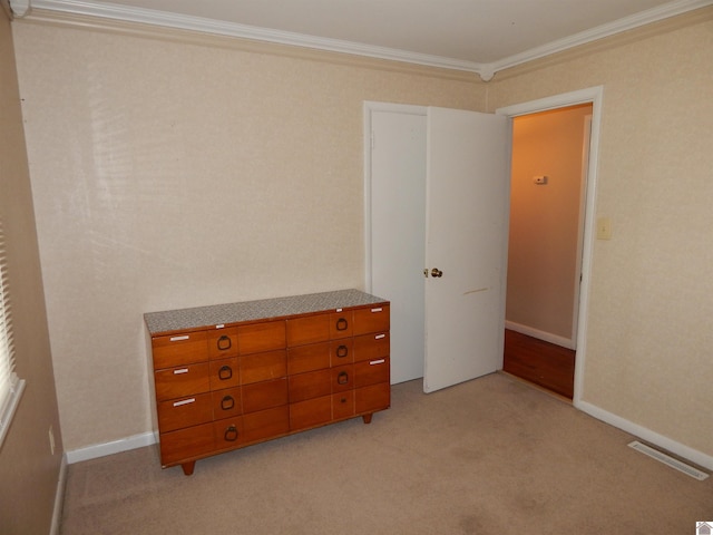 unfurnished bedroom featuring light colored carpet and ornamental molding