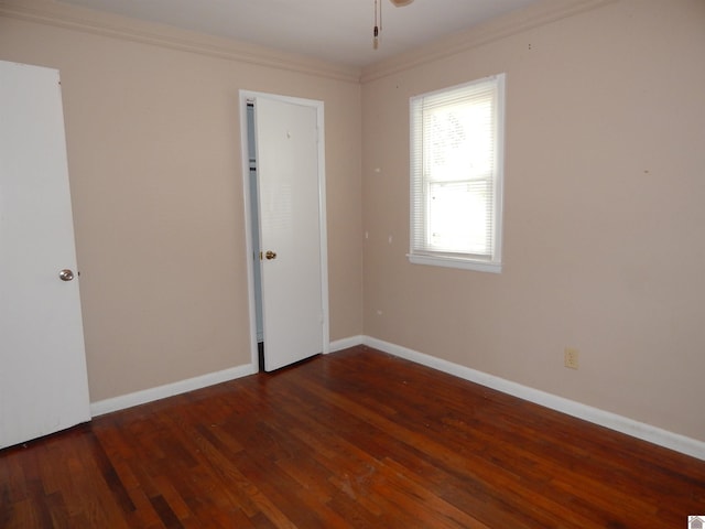 unfurnished room featuring ornamental molding and dark hardwood / wood-style floors