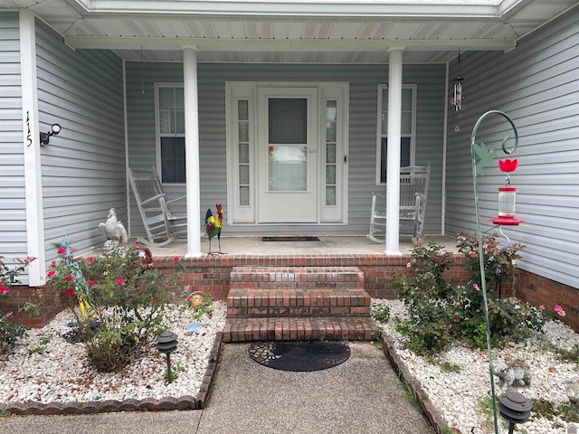 doorway to property featuring covered porch