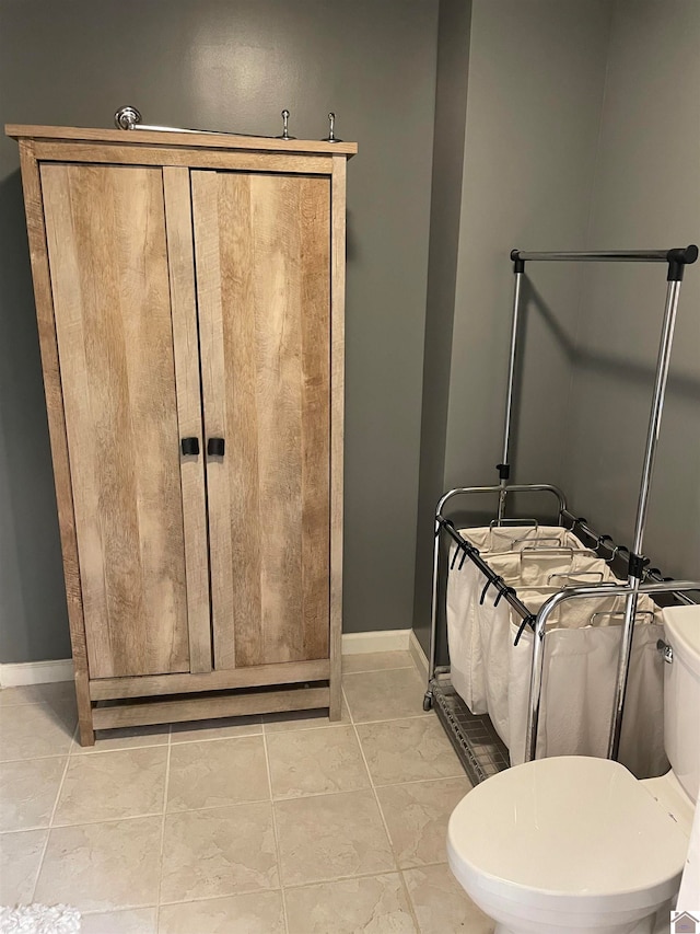 bathroom featuring tile patterned flooring and toilet