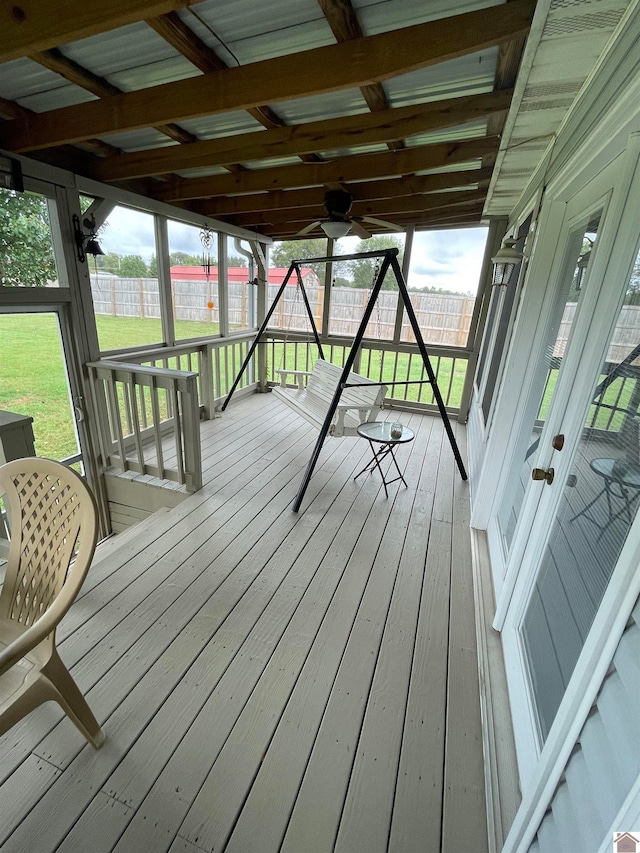 wooden terrace with a lawn and ceiling fan