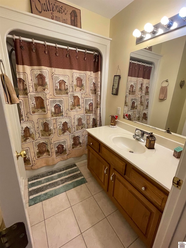 bathroom featuring a shower with curtain, vanity, and tile patterned floors