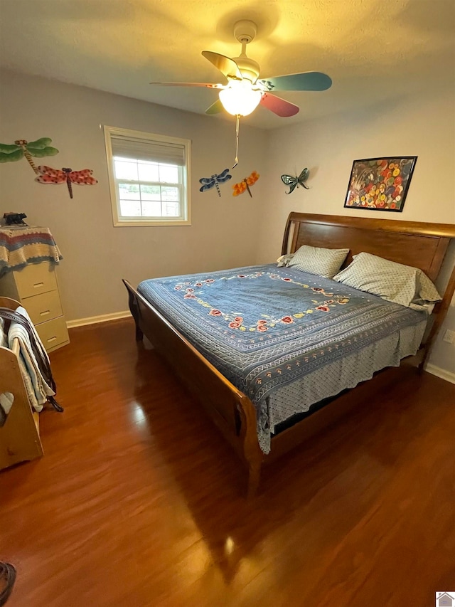 bedroom featuring dark hardwood / wood-style flooring and ceiling fan