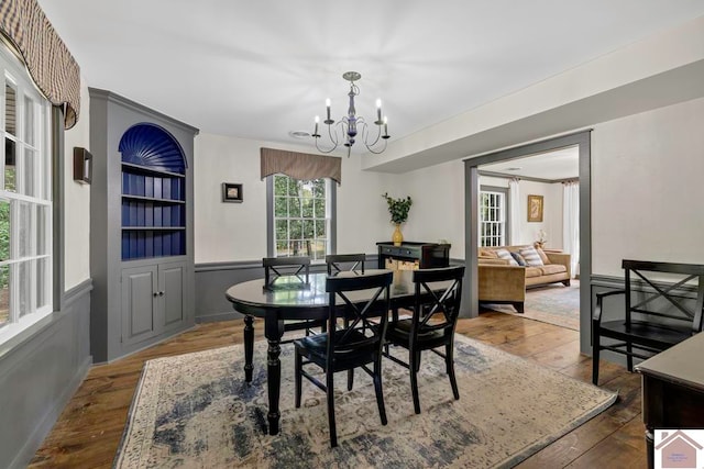 dining area with a notable chandelier and hardwood / wood-style floors