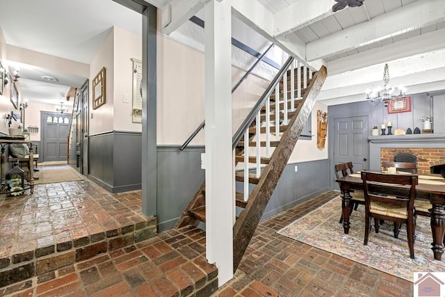 interior space with a notable chandelier and beam ceiling