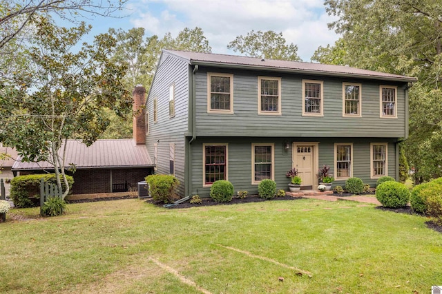 view of front of property with cooling unit and a front yard