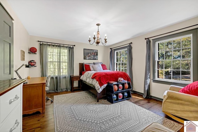 bedroom with dark hardwood / wood-style flooring and multiple windows