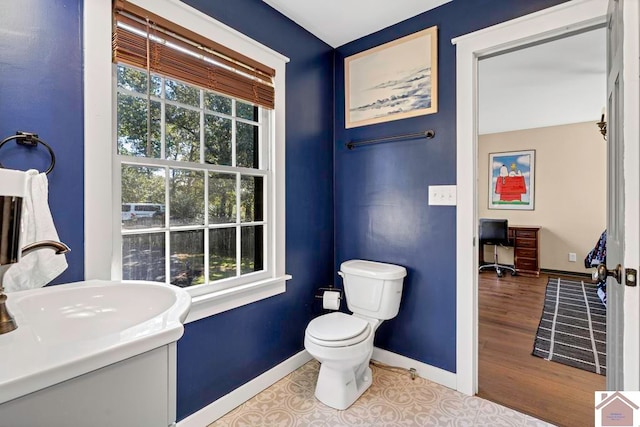 bathroom featuring vanity, hardwood / wood-style floors, and toilet