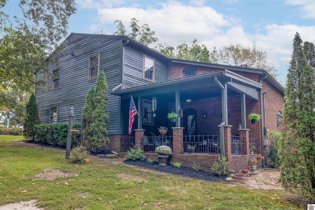 view of front of home featuring a front yard and covered porch