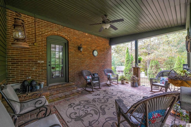 sunroom / solarium featuring ceiling fan and wooden ceiling