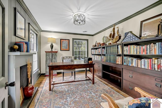 office space with light wood-type flooring and crown molding