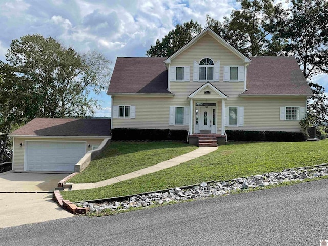 view of front of house featuring a garage and a front lawn