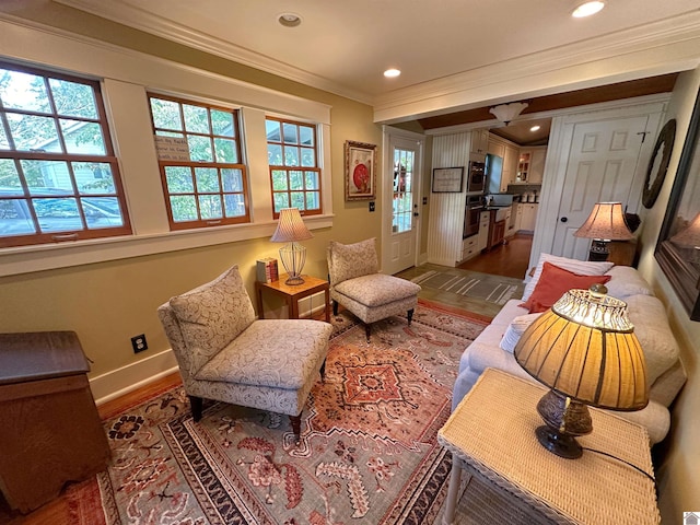 living area featuring ornamental molding, plenty of natural light, and dark hardwood / wood-style flooring