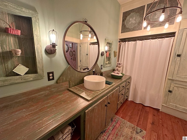 bathroom featuring a shower with shower curtain, vanity, a chandelier, and hardwood / wood-style floors