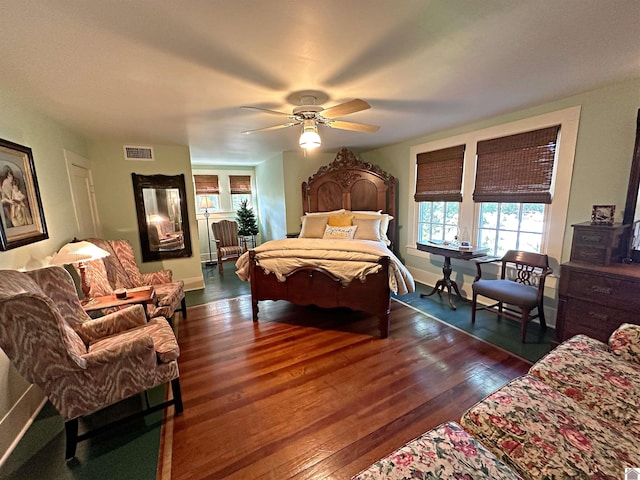 bedroom featuring ceiling fan and dark hardwood / wood-style floors