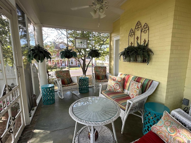 sunroom / solarium with decorative columns and ceiling fan