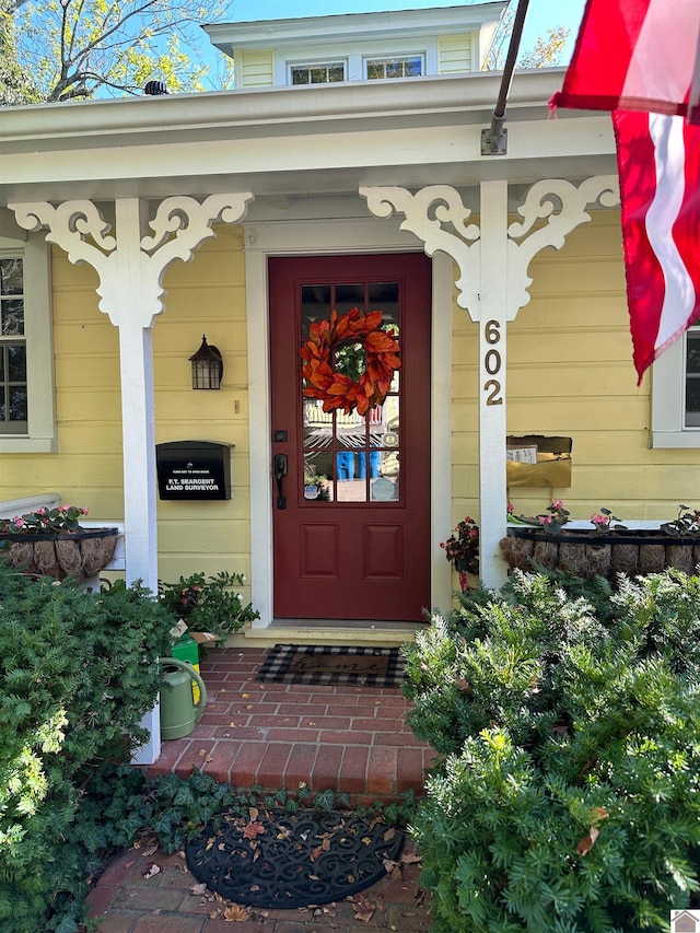 doorway to property featuring covered porch