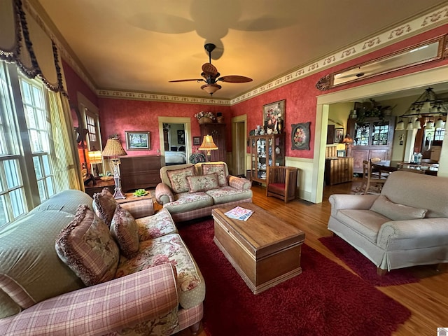 living room with ornamental molding, ceiling fan, and hardwood / wood-style floors