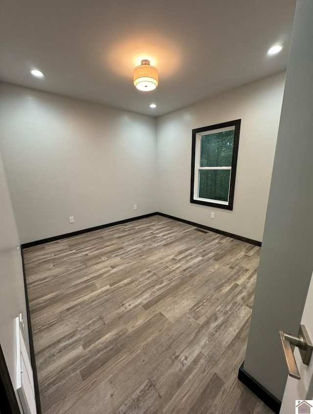 spare room with hardwood / wood-style flooring