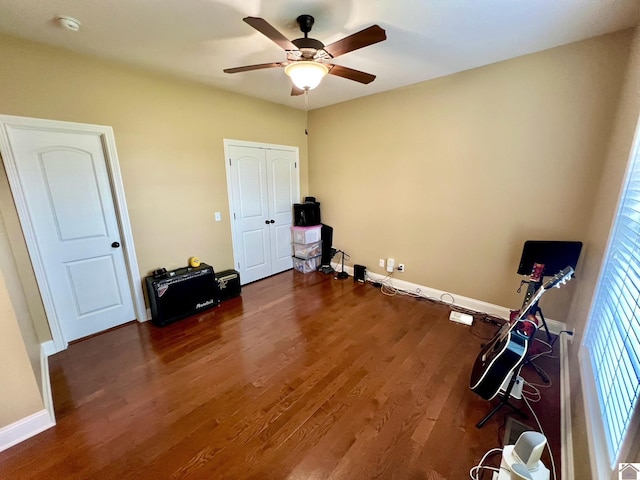 miscellaneous room featuring ceiling fan and dark hardwood / wood-style flooring