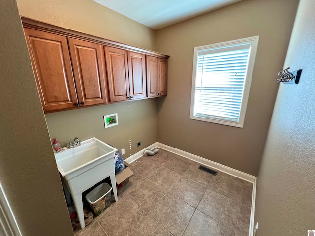 washroom with hookup for a washing machine, light tile patterned flooring, hookup for an electric dryer, cabinets, and gas dryer hookup