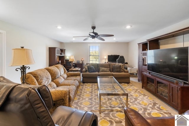 carpeted living room featuring ceiling fan