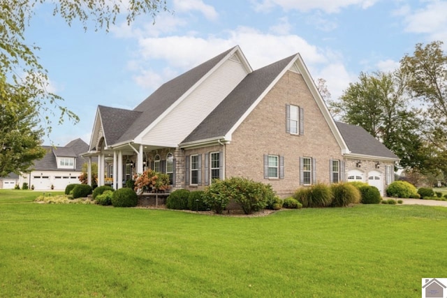 view of front of home featuring a garage, a porch, and a front lawn