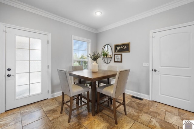 dining area featuring crown molding