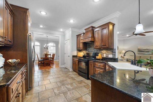 kitchen featuring custom range hood, ceiling fan with notable chandelier, decorative light fixtures, sink, and electric range