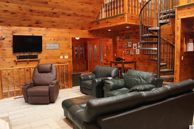 living room with high vaulted ceiling and wooden walls