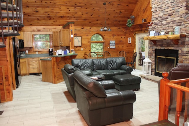 living room with high vaulted ceiling, wood walls, wooden ceiling, and a fireplace