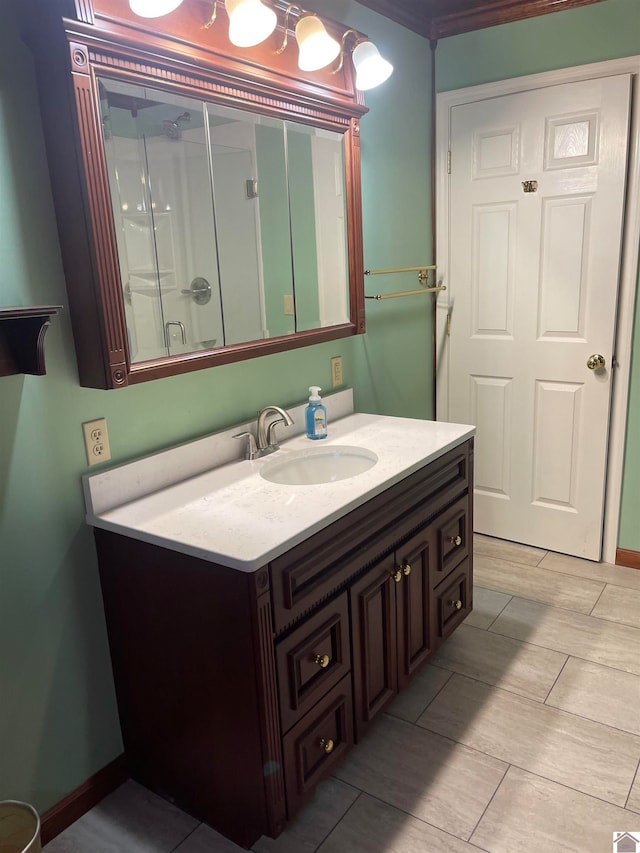 bathroom with ornamental molding and vanity