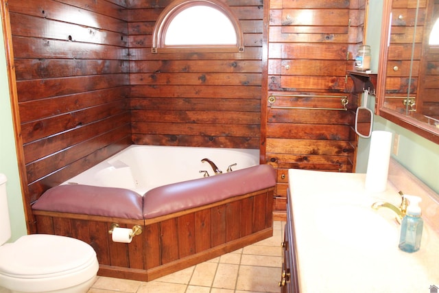 bathroom featuring a bathing tub, tile patterned floors, vanity, and toilet